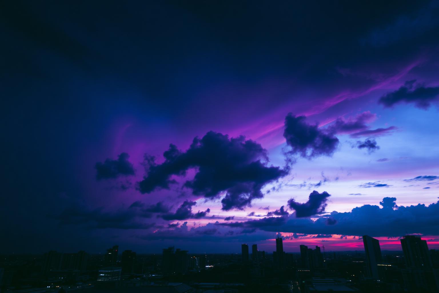 Storm sky over a city skyline at dusk